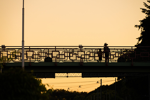 Gothenburg, Sweden - July 11 2022: Two people standing on a footbridge.