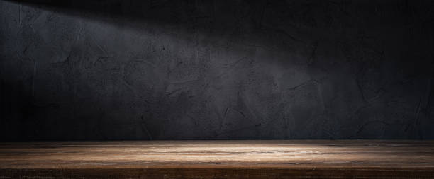 istock Wooden table or counter top with black stone wall background 1452767595