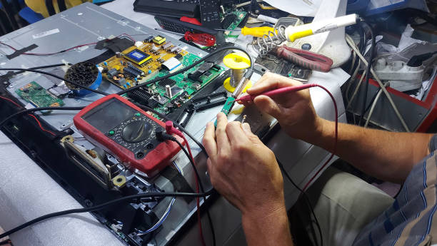 istock Closeup of hands checking board with multimeter 1452768484