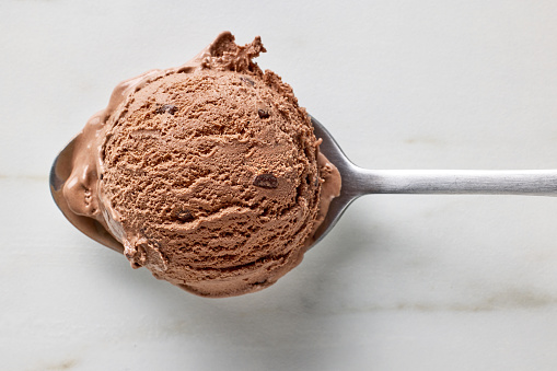 chocolate ice cream ball in a spoon, top view