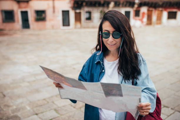istock Woman holding map for finding her way in venice 1452769757
