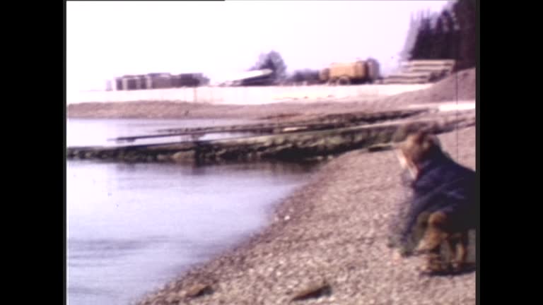 70's 8mm Footage - 2 Years Old Boy Throwing Pebbles at the Beach in 1970s