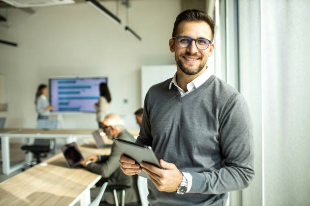 istock Confident young man businessman working inside modern office on a digital tablet 1452771751