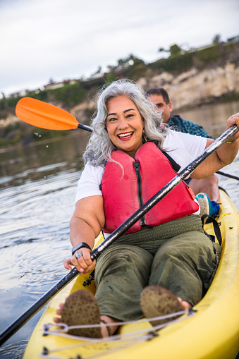A beautiful senior Hispanic couple kayaking