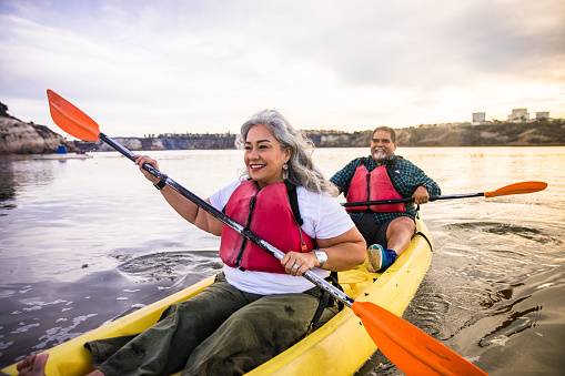 A beautiful senior Hispanic couple kayaking
