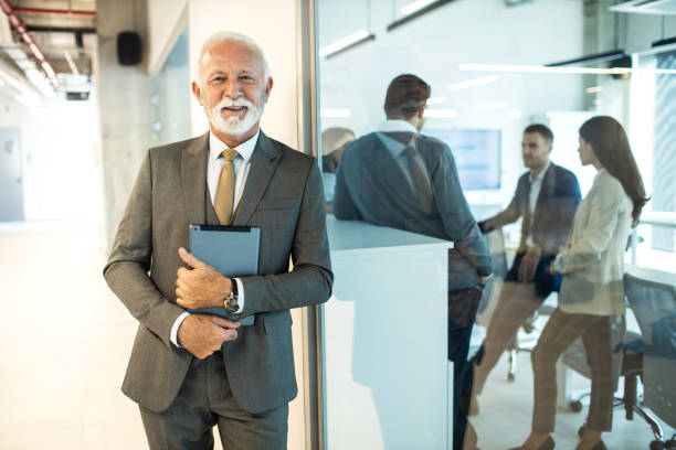 istock Confident senior man businessman working inside modern office on a digital tablet 1452777126