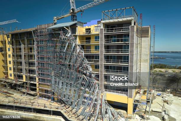 Aerial View Of Ruined By Hurricane Ian Construction Scaffolding On High Apartment Building Site In Port Charlotte Usa Stock Photo - Download Image Now