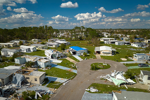 Destroyed by hurricane Ian suburban houses in Florida mobile home residential area. Consequences of natural disaster.