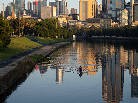 Melbourne skyline and Yarra river with early morning rower
