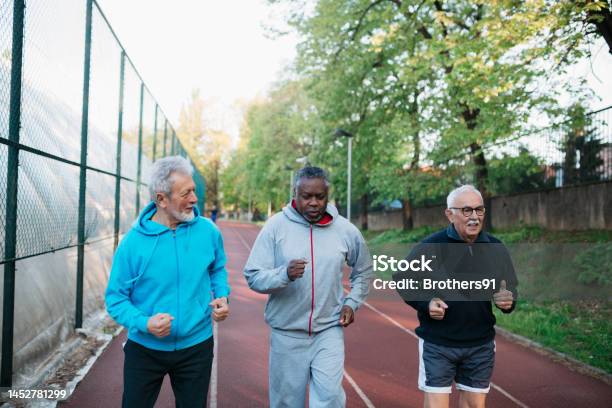 Diverse Active Seniors Doing Jogging Workout On Outdoor Sports Court Stock Photo - Download Image Now
