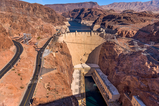 A panoramic overview of Hoover Dam and its surrounding area, as seen from Mike O'Callaghan - Pat Tillman Memorial Bridge, on a bright sunny Winter day. Nevada - Arizona, USA.