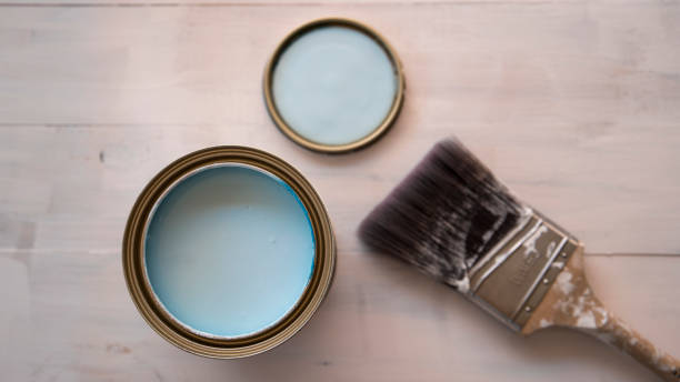 istock Paint brush on paint can with partially painted timber surface in the background 1452782973