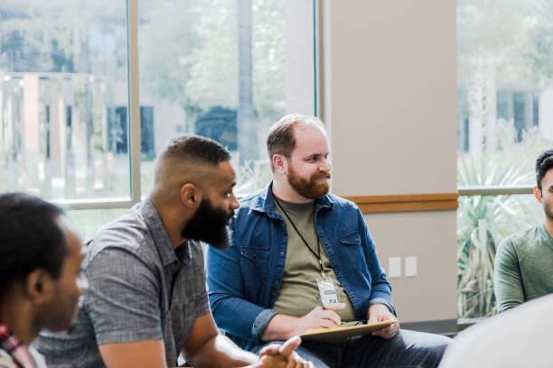 istock Diverse men listen attentively to unseen group member 1452785717
