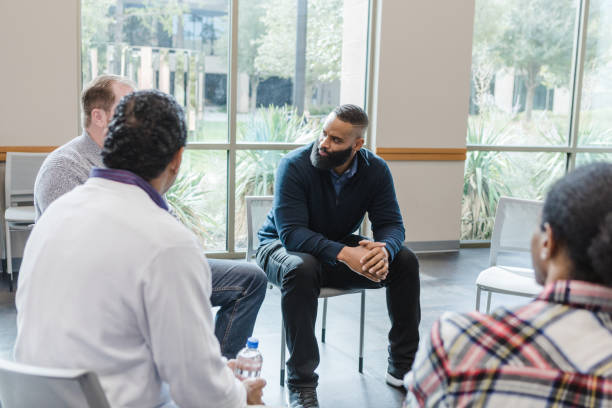 istock Diverse men have serious conversation in group therapy 1452785729