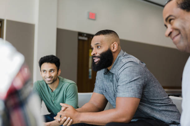 Diverse smile during support group meeting stock photo