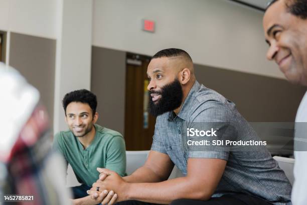 Diverse Smile During Support Group Meeting Stock Photo - Download Image Now - Group Therapy, Men, Only Men