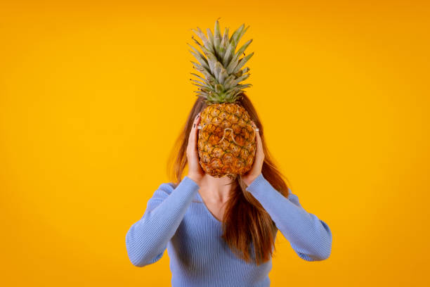 istock A pineapple in sunglasses in a studio on a yellow background, healthy, summer 1452787355