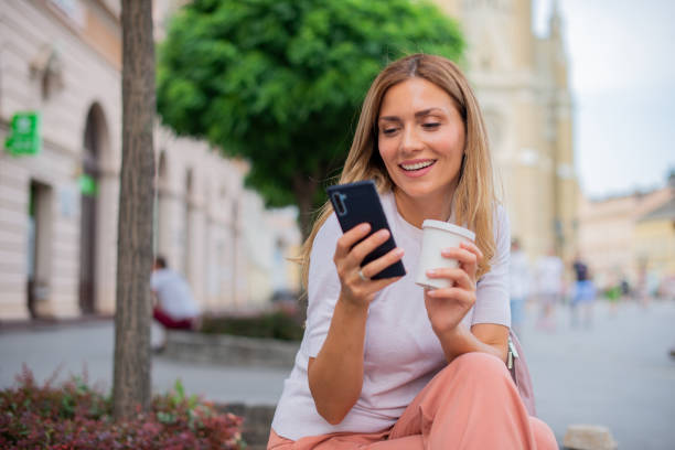 istock Mid adult woman using smart phone 1452788432