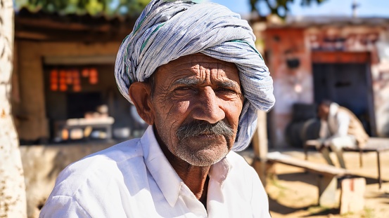 14 December 2022, Reengus, Rajasthan, India. Indian aged man looking at camera.