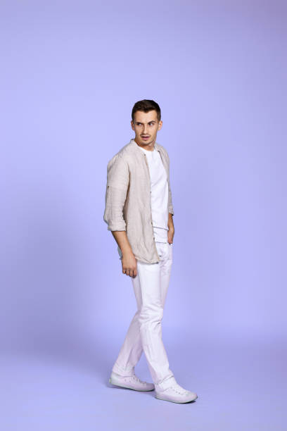 istock happy man walks isolated on violet background. 1452789086