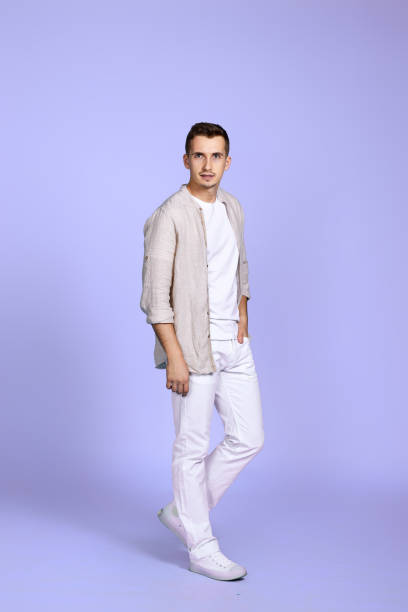 istock man in casual shirt posing on purple background. 1452789091