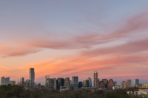 A scenic view of the city of Austin with a beautiful sunset in the background