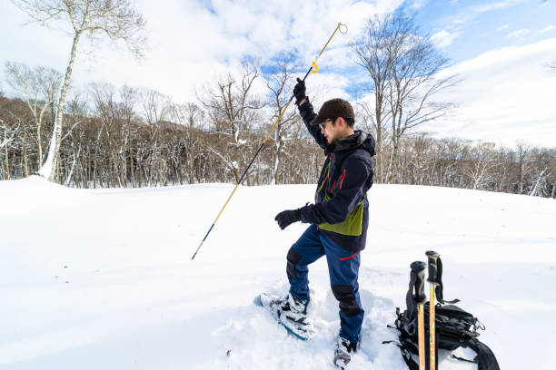 istock Man probing the snow with an avalanche snow probe 1452794620