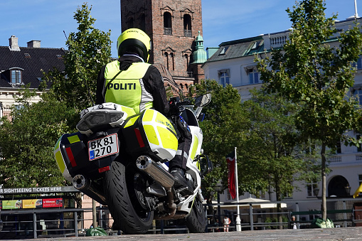 Danish policeofficer on motorbike in the streets of Copenhagen on a sunny day in Denmark