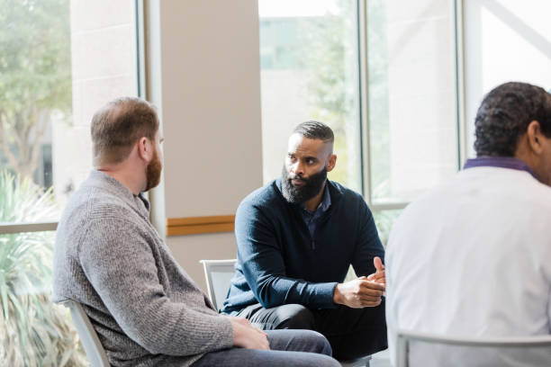 istock During break in group therapy, man listens carefully to friend 1452796631