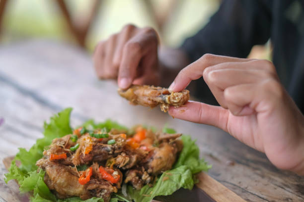 istock Unrecognizable Women Eating Crispy Chicken Wing 1452798186