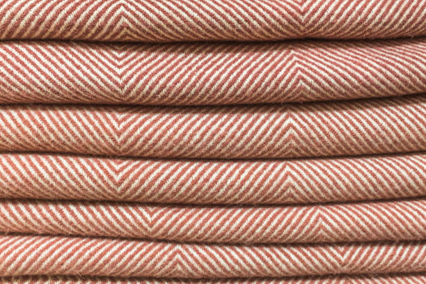 istock Stack of wool scarves with brown diamond stripes 1452803350