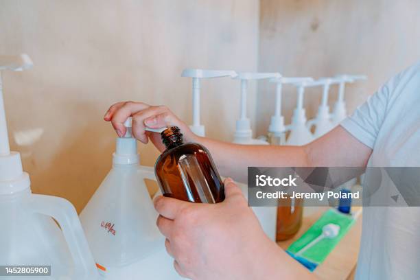 Young Womans Hands Pumping Shampoo Or Body Wash From A Bottle Making Sustainable Choices At A Plasticfree Retail Store Stock Photo - Download Image Now