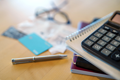 Calculator, pen and notebook on working desk