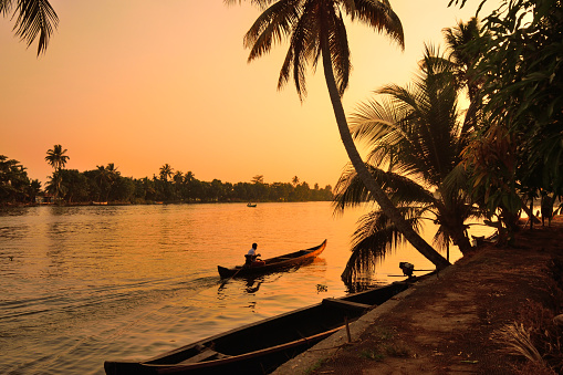 Boat sailing in kerala backwaters during sunset.