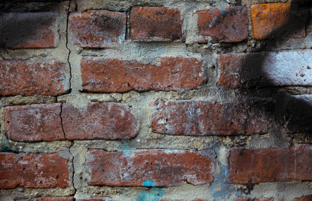 istock a brick wall with a piece of graffiti 1452812684