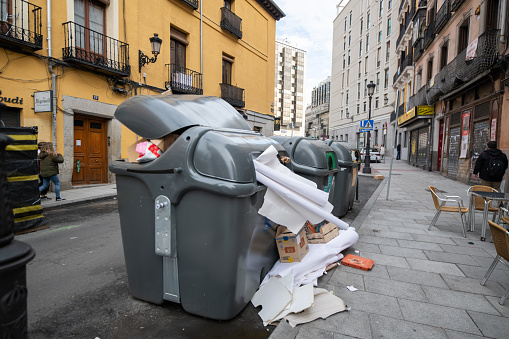 Overflowing trash and recycling dispensers in Madrid, Spain