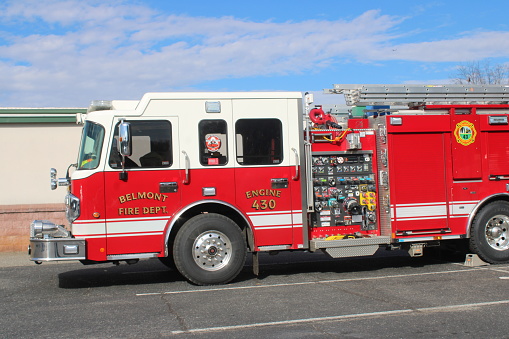 Belmont, NC, USA-November 23, 2022: Bright red fire engine from the Belmont Fire Department parked in local shopping center