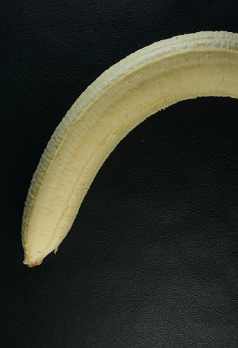 texture of big banana without skin, black background