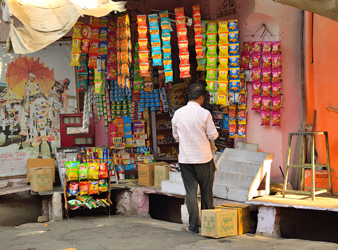 Pushkar, India - November 01, 2017: A man buying items from a stationery store.