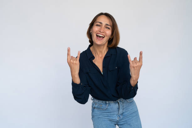 istock Thrilled woman making rock gesture 1452828169