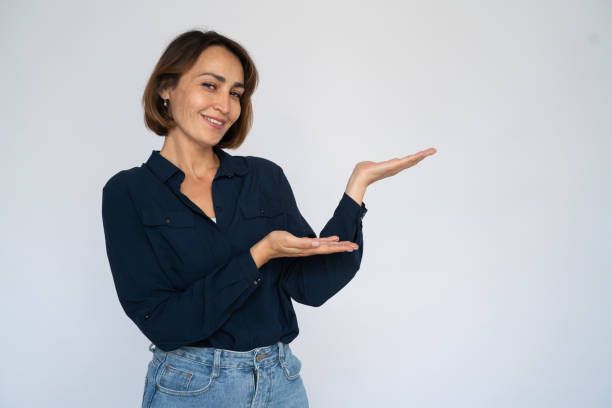 istock Satisfied woman holding something invisible 1452828176