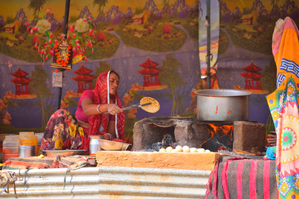 Pushkar, India - November 02, 2017: A woman cooking roti in a roadside eatery,