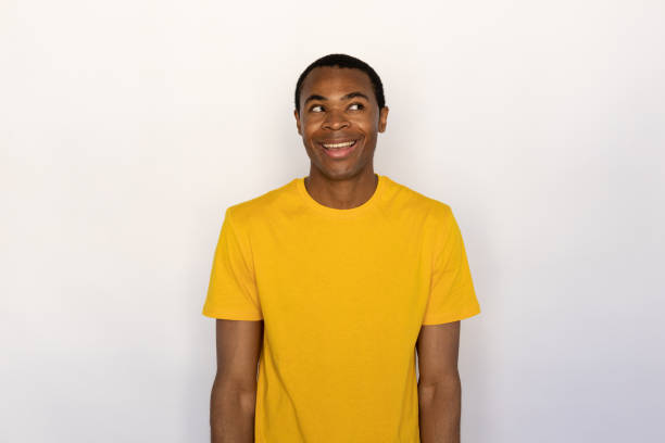 istock Portrait of curious young man looking away and smiling 1452829421