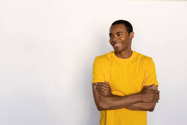 istock Portrait of happy young man posing with folded arms 1452829494
