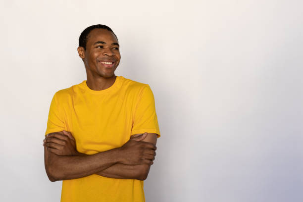istock Portrait of positive young man posing with folded arms 1452830121