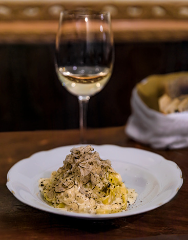 Fresh pasta with truffle sauce, cooked in a pecorino cheese wheel with shaved black truffles at an Italian restaurant, Centro Storico, Florence, Italy