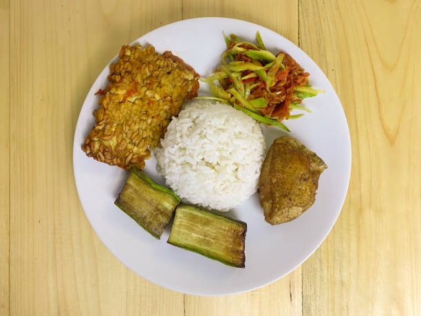 istock Rice, fried tempe, fried eggplant, fried chicken, and mango chili sauce for lunch or dinner 1452830500