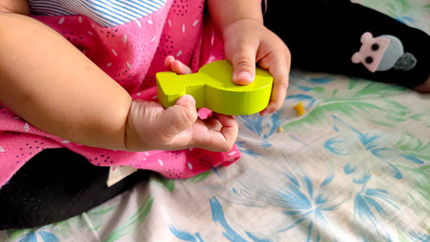 istock Baby girl holding blocks 1452830680