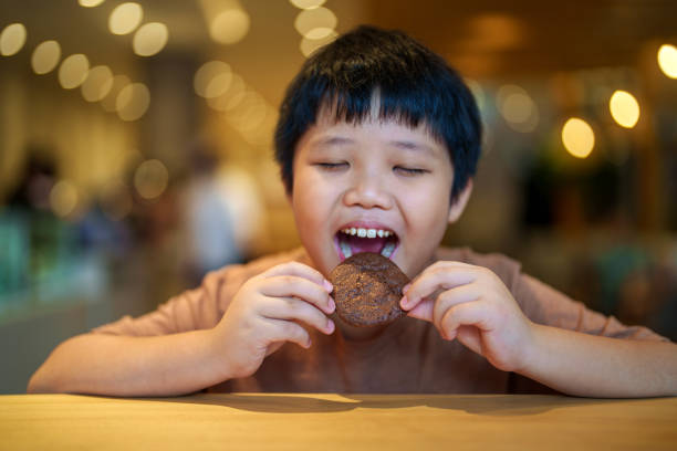Smiling boy enjoying his unhealthy school lunch