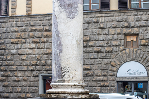 A shop in the background of War monument to the Battle of Marciano of the Italian War (of 1551-59) in the Piazza San Felice in the city of Florence. It says: In memory of the triumphant battle against the Marciano. Also known as the Habsburg–Valois War and the Last Italian War, it was triggered when Henry II of France declared war on Holy Roman Emperor Charles V. He wanted to recapture parts of Italy with the intent of recapturing parts of Italy to ensure the French rather than the Habsburgs ruled Europe. The war was settled by the Treaty of Cateau-Cambrésis.